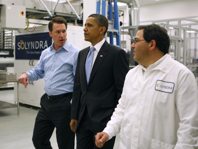 Ben Bierman (R) and Chris Gronet (L) lead U.S. President Barack Obama on a tour of the Solyndra solar panel company May 26, 2010 in Fremont, California.